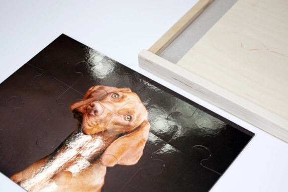 Wooden photo puzzle with a dog on it.