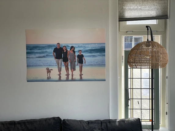 Beach photo of family with dog printed as a poster and hung with handy adhesive strips.